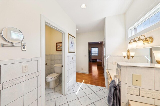 900 Deer Circle Dr, Carlyle, IL 62231 - bathroom with tile walls, tile patterned floors, toilet, a wainscoted wall, and recessed lighting