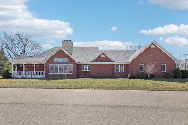900 Deer Circle Dr, Carlyle, IL 62231 - single story home with a front yard, brick siding, a chimney, and covered porch