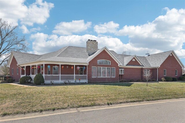 900 Deer Circle Dr, Carlyle, IL 62231 - view of front of house featuring covered porch, brick siding, a front lawn, and a chimney