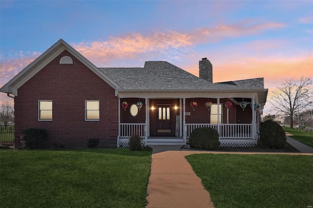900 Deer Circle Dr, Carlyle, IL 62231 - bungalow-style home featuring covered porch, brick siding, a front lawn, and a chimney