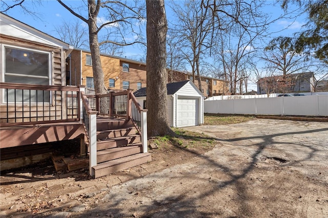 554 S Clay Ave, Saint Louis, MO 63122 - view of yard with fence, driveway, a wooden deck, and a garage