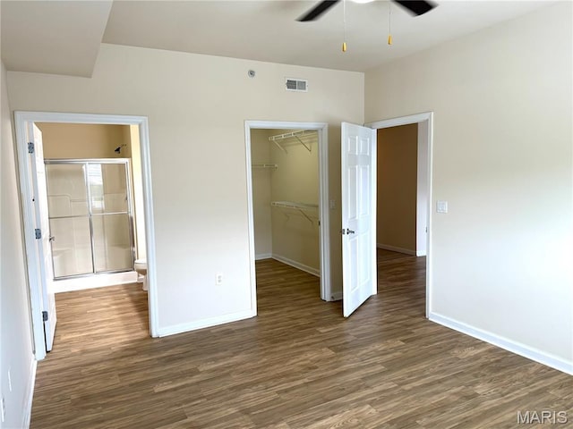2 Monarch Trace Ct Unit 103, Chesterfield, MO 63017 - unfurnished bedroom featuring wood finished floors, baseboards, a spacious closet, and a closet