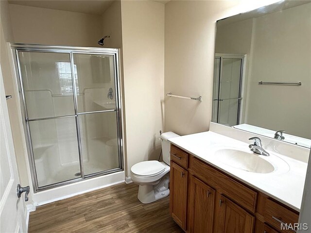 2 Monarch Trace Ct Unit 103, Chesterfield, MO 63017 - full bathroom featuring wood finished floors, a stall shower, and toilet