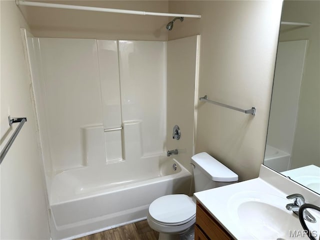 2 Monarch Trace Ct Unit 103, Chesterfield, MO 63017 - bathroom featuring toilet, vanity, wood finished floors, and shower / bathtub combination