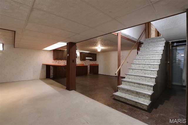 8032 Blue Mound Dr, Saint Rose, IL 62230 - finished below grade area featuring stairway, dark colored carpet, a drop ceiling, and wallpapered walls