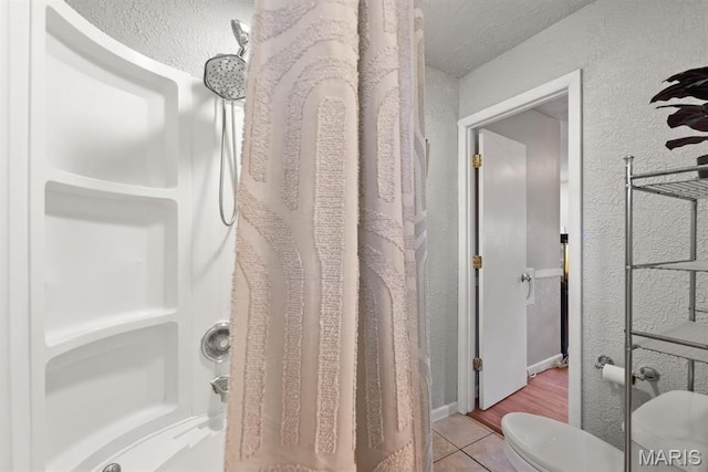 2755 Patterson Rd, Florissant, MO 63031 - bathroom with a shower with shower curtain, a textured wall, and tile patterned flooring