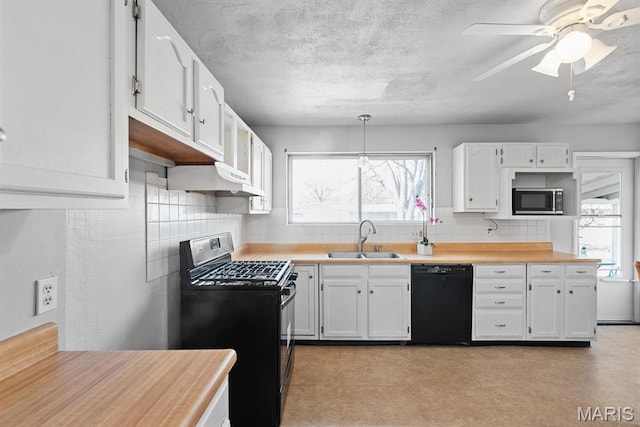 2755 Patterson Rd, Florissant, MO 63031 - kitchen featuring dishwasher, gas range, stainless steel microwave, and white cabinets