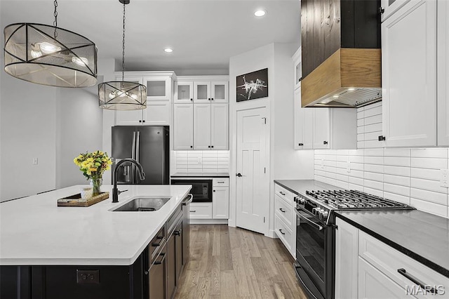 1520 Oglesby Dr, Edwardsville, IL 62025 - kitchen featuring range with gas cooktop, freestanding refrigerator, a sink, premium range hood, and black microwave