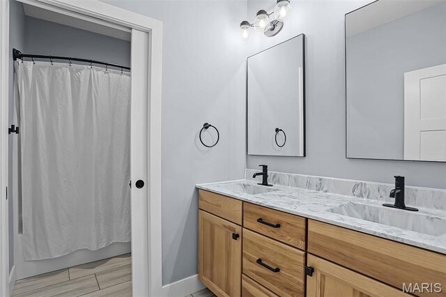 1520 Oglesby Dr, Edwardsville, IL 62025 - bathroom featuring double vanity, baseboards, and shower / bath combination with curtain