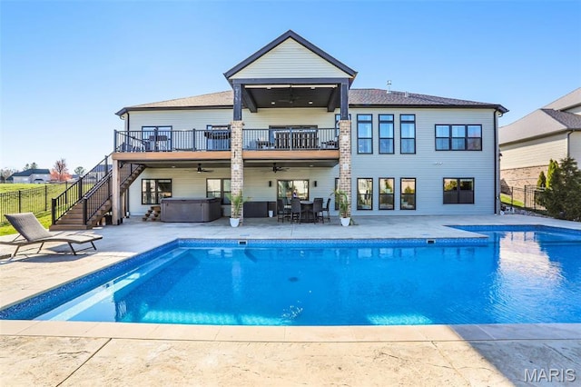 1520 Oglesby Dr, Edwardsville, IL 62025 - back of property with a hot tub, ceiling fan, stairway, a balcony, and fence