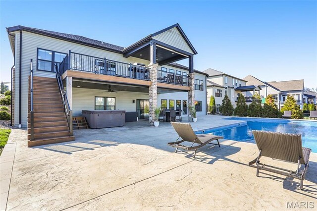 1520 Oglesby Dr, Edwardsville, IL 62025 - back of property with a hot tub, a patio area, stairs, a balcony, and a residential view