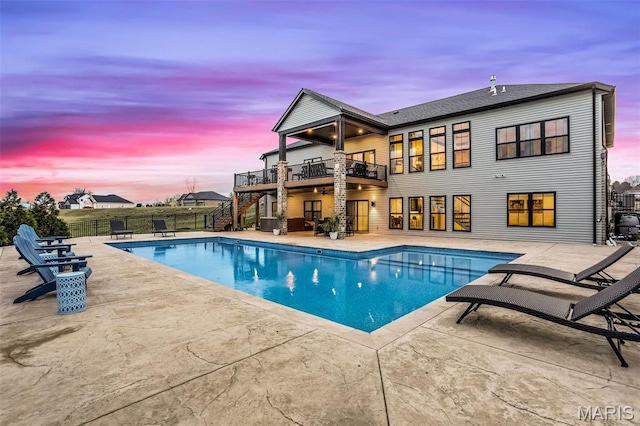 1520 Oglesby Dr, Edwardsville, IL 62025 - pool at dusk with stairs, a fenced backyard, and a patio area