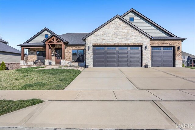 1520 Oglesby Dr, Edwardsville, IL 62025 - view of front facade with an attached garage, concrete driveway, a front yard, brick siding, and stone siding