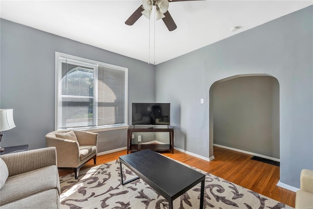 2107 Russell Blvd, Saint Louis, MO 63104 - living area featuring arched walkways, ceiling fan, wood finished floors, and baseboards
