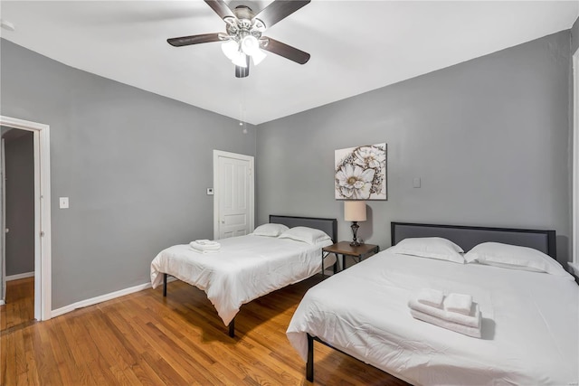 2107 Russell Blvd, Saint Louis, MO 63104 - bedroom featuring baseboards, wood finished floors, and a ceiling fan