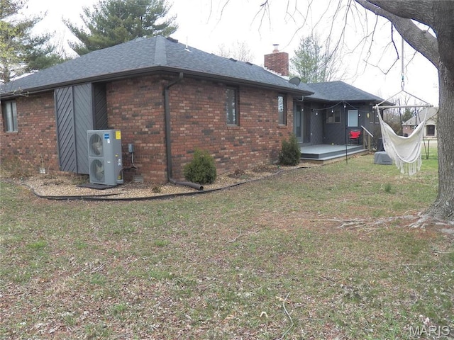 417 Carriage Pl, Lebanon, MO 65536 - rear view of house with brick siding, a cooling unit, a chimney, and a lawn