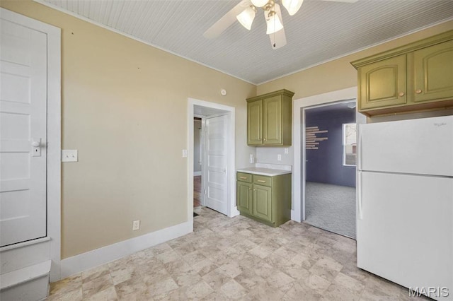 1052 Market St, Saint Genevieve, MO 63670 - kitchen featuring green cabinets, freestanding refrigerator, ceiling fan, baseboards, and light countertops