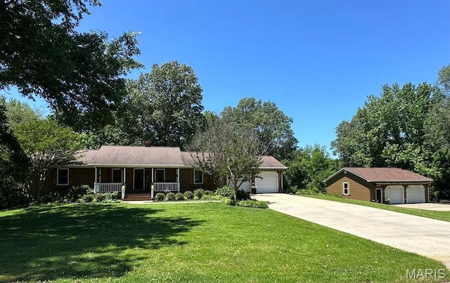 14348 Hidden Trails Cir, Dexter, MO 63841 - ranch-style home featuring a porch, concrete driveway, a garage, and a front lawn
