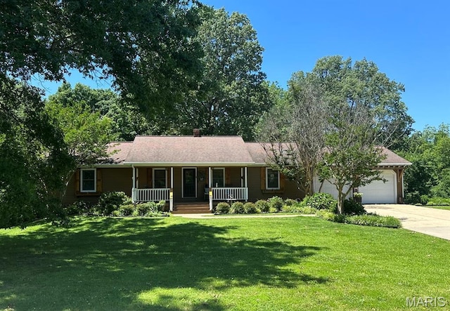 14348 Hidden Trails Cir, Dexter, MO 63841 - ranch-style house featuring a porch, driveway, an attached garage, and a front lawn