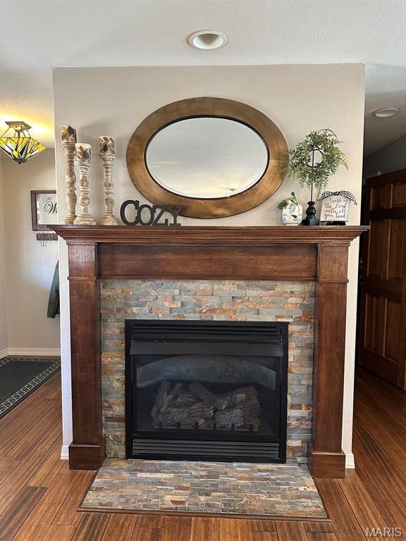 14348 Hidden Trails Cir, Dexter, MO 63841 - detailed view of wood finished floors, a fireplace, and baseboards