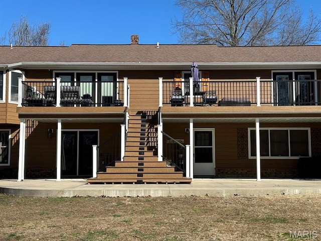 14348 Hidden Trails Cir, Dexter, MO 63841 - back of house with stairs, a patio area, and a chimney