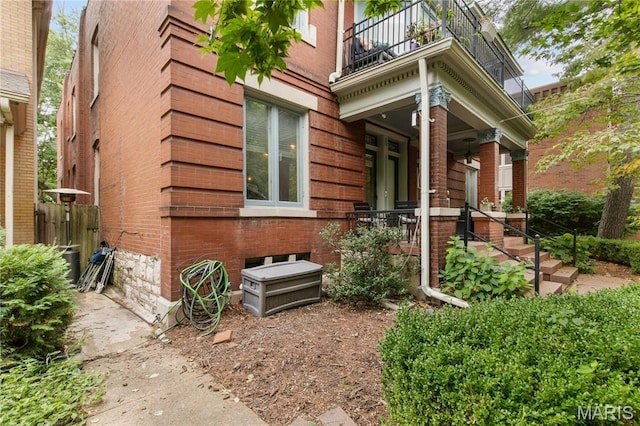 4486 Laclede Ave Unit 4486, Saint Louis, MO 63108 - view of exterior entry with a balcony, covered porch, and brick siding
