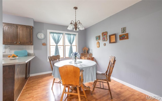 400 S Hickory St, Salem, MO 65560 - dining room with light wood-style flooring, a chandelier, and baseboards