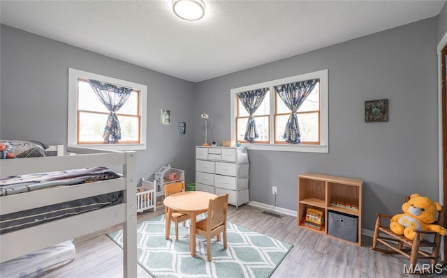 400 S Hickory St, Salem, MO 65560 - bedroom featuring light wood finished floors, baseboards, and a textured ceiling