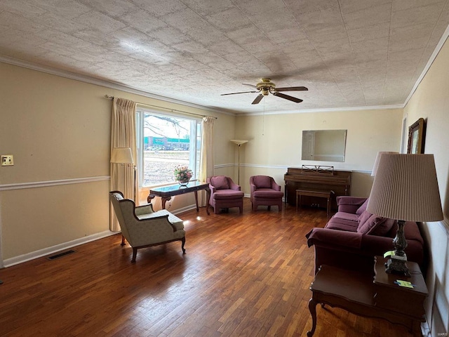 living room featuring wood finished floors, ceiling fan, and crown molding