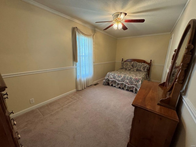 bedroom featuring carpet floors, ornamental molding, ceiling fan, and baseboards