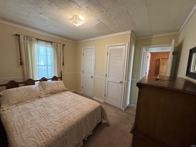 carpeted bedroom with crown molding and baseboards