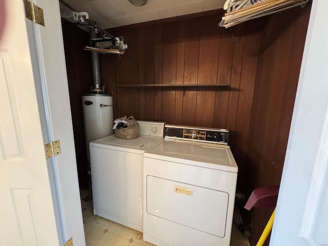 laundry room featuring independent washer and dryer and wooden walls