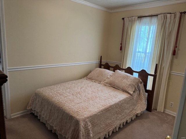 carpeted bedroom with ornamental molding and baseboards