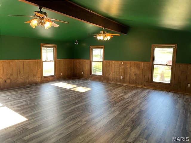 22 Coachman Ln, Villa Ridge, MO 63089 - spare room featuring wainscoting, wood finished floors, a ceiling fan, wooden walls, and plenty of natural light
