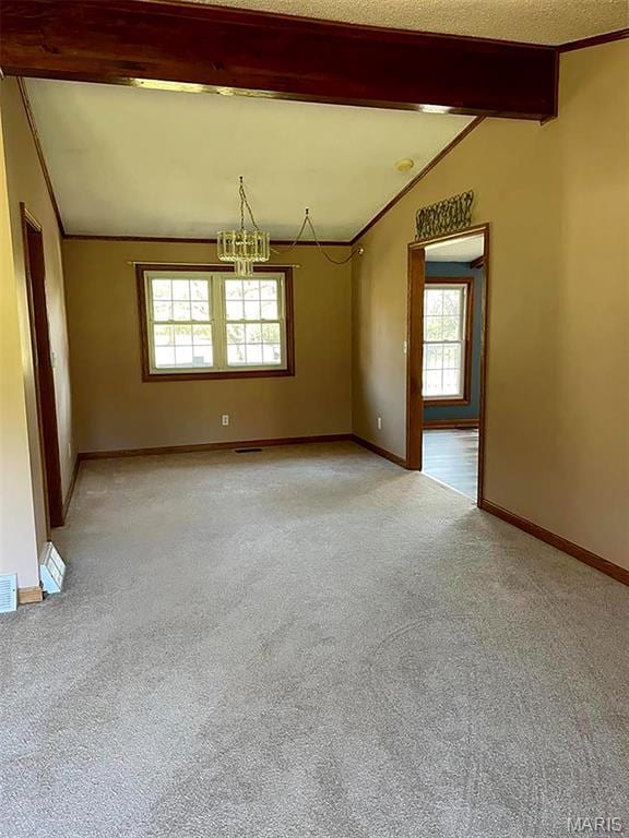 22 Coachman Ln, Villa Ridge, MO 63089 - empty room featuring a chandelier, healthy amount of natural light, and light carpet
