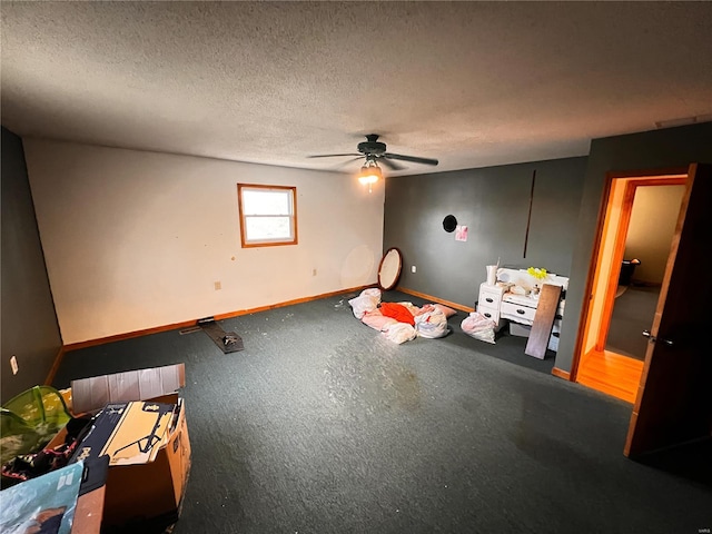 1505 Shelley Dr, Vandalia, IL 62471 - unfurnished bedroom featuring baseboards, a textured ceiling, ceiling fan, and carpet