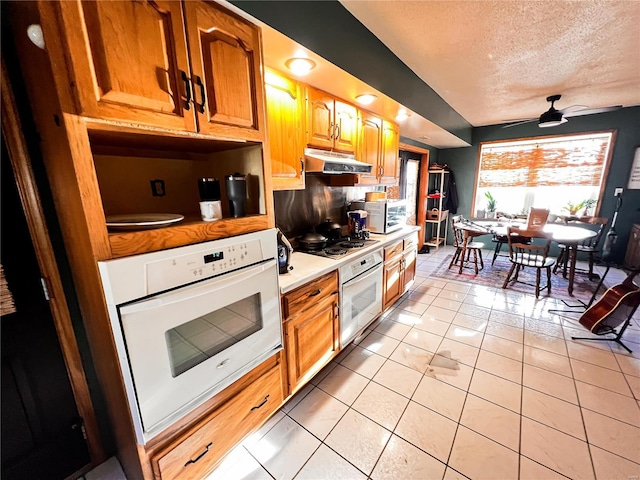 1505 Shelley Dr, Vandalia, IL 62471 - kitchen with oven, under cabinet range hood, a textured ceiling, light countertops, and a ceiling fan