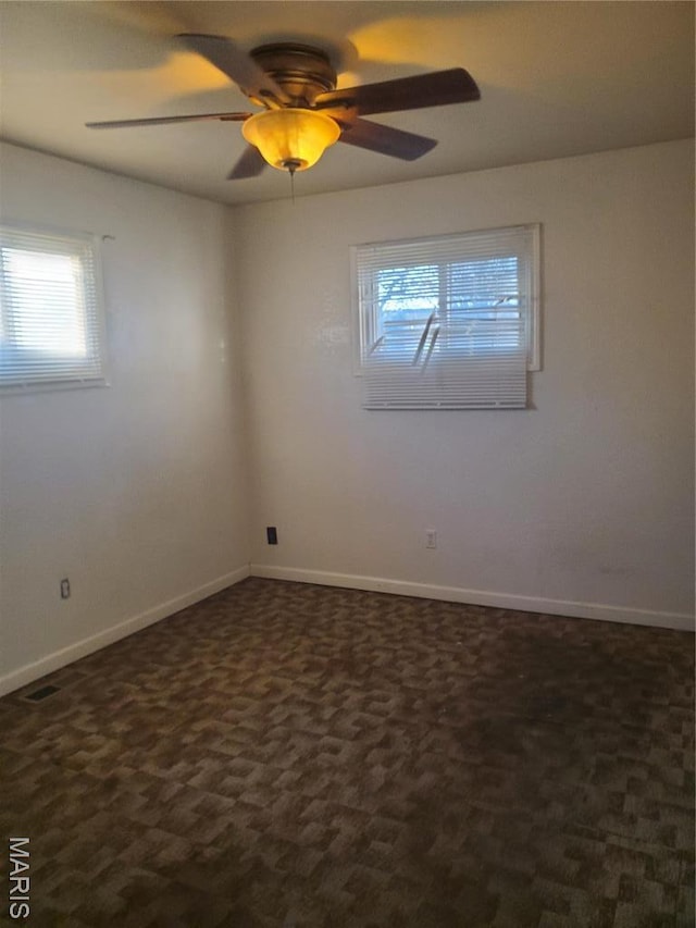 20 Leonard Dr, Cahokia, IL 62206 - spare room featuring dark colored carpet, baseboards, and a ceiling fan