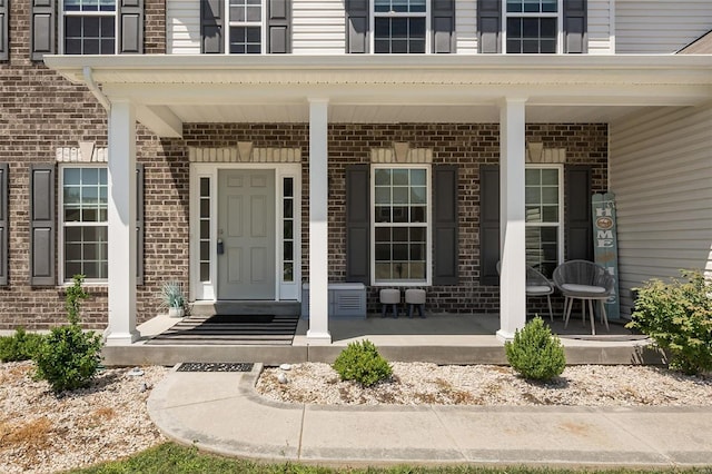 237 Mason Glen Dr, Lake St Louis, MO 63367 - doorway to property with covered porch and brick siding