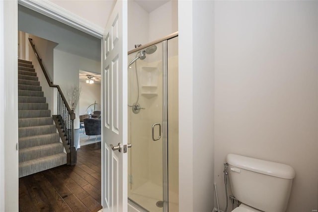 237 Mason Glen Dr, Lake St Louis, MO 63367 - bathroom with hardwood / wood-style floors, a shower stall, a ceiling fan, and toilet
