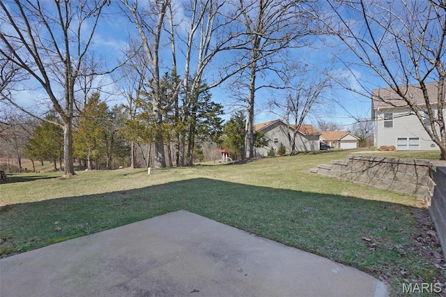 304 Spotted Fawn, Wentzville, MO 63385 - view of green lawn with a patio area and a garage