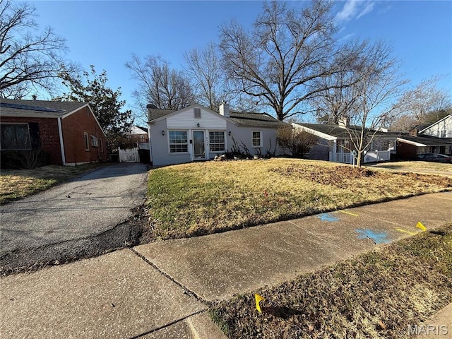 8510 Eulalie Ave, Saint Louis, MO 63144 - single story home with driveway, a front yard, and a chimney