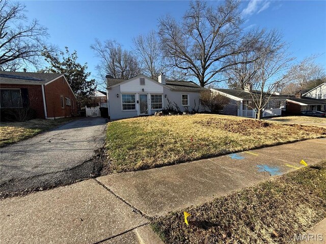 8510 Eulalie Ave, Saint Louis, MO 63144 - single story home with driveway, a front yard, and a chimney