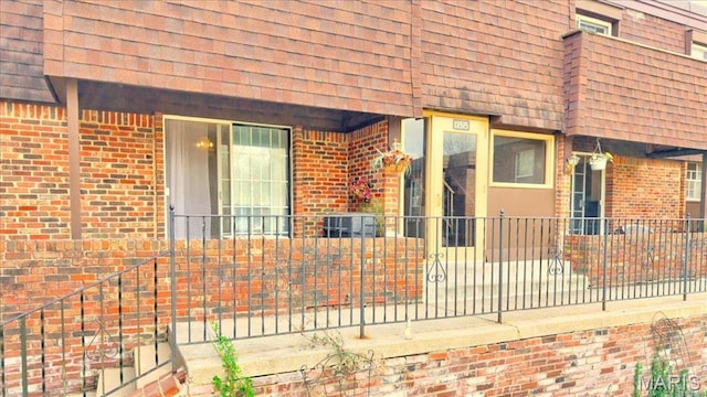 13515 Coliseum Dr Unit A, Chesterfield, MO 63017 - doorway to property with brick siding and a shingled roof