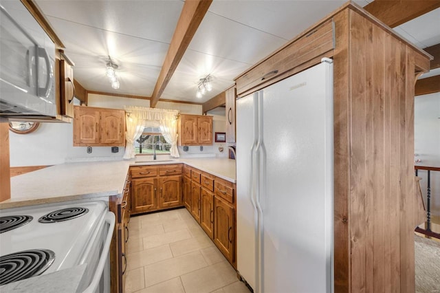 12044 State Route A, Saint Genevieve, MO 63670 - kitchen featuring white appliances, light countertops, beam ceiling, light tile patterned floors, and brown cabinetry