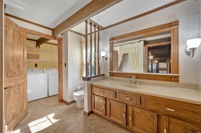 12044 State Route A, Saint Genevieve, MO 63670 - bathroom with washer and dryer, tile patterned floors, vanity, toilet, and wallpapered walls