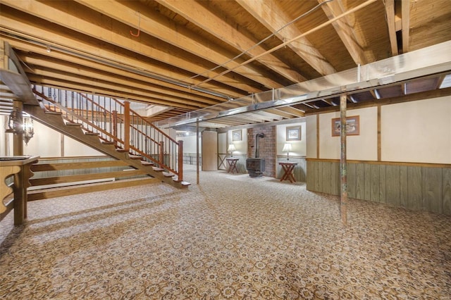 12044 State Route A, Saint Genevieve, MO 63670 - finished basement with a wood stove, stairs, wainscoting, and carpet flooring