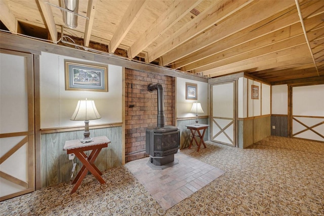 12044 State Route A, Saint Genevieve, MO 63670 - interior space with a wood stove, a wainscoted wall, carpet floors, and wood walls
