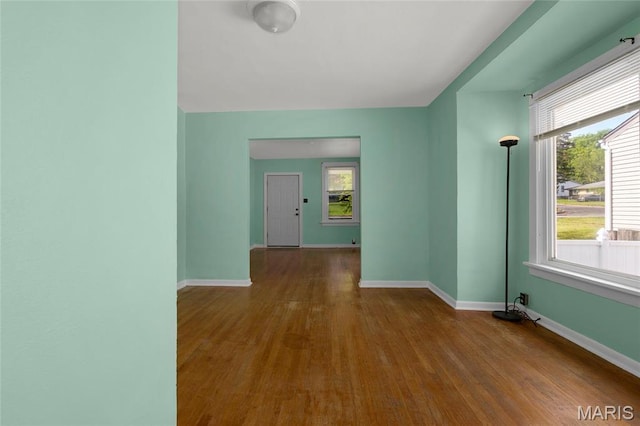 hall with wood finished floors and baseboards