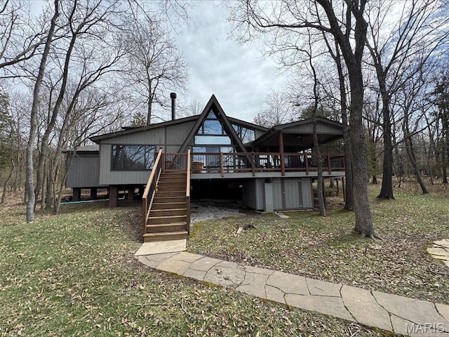 rear view of property with a deck and stairs